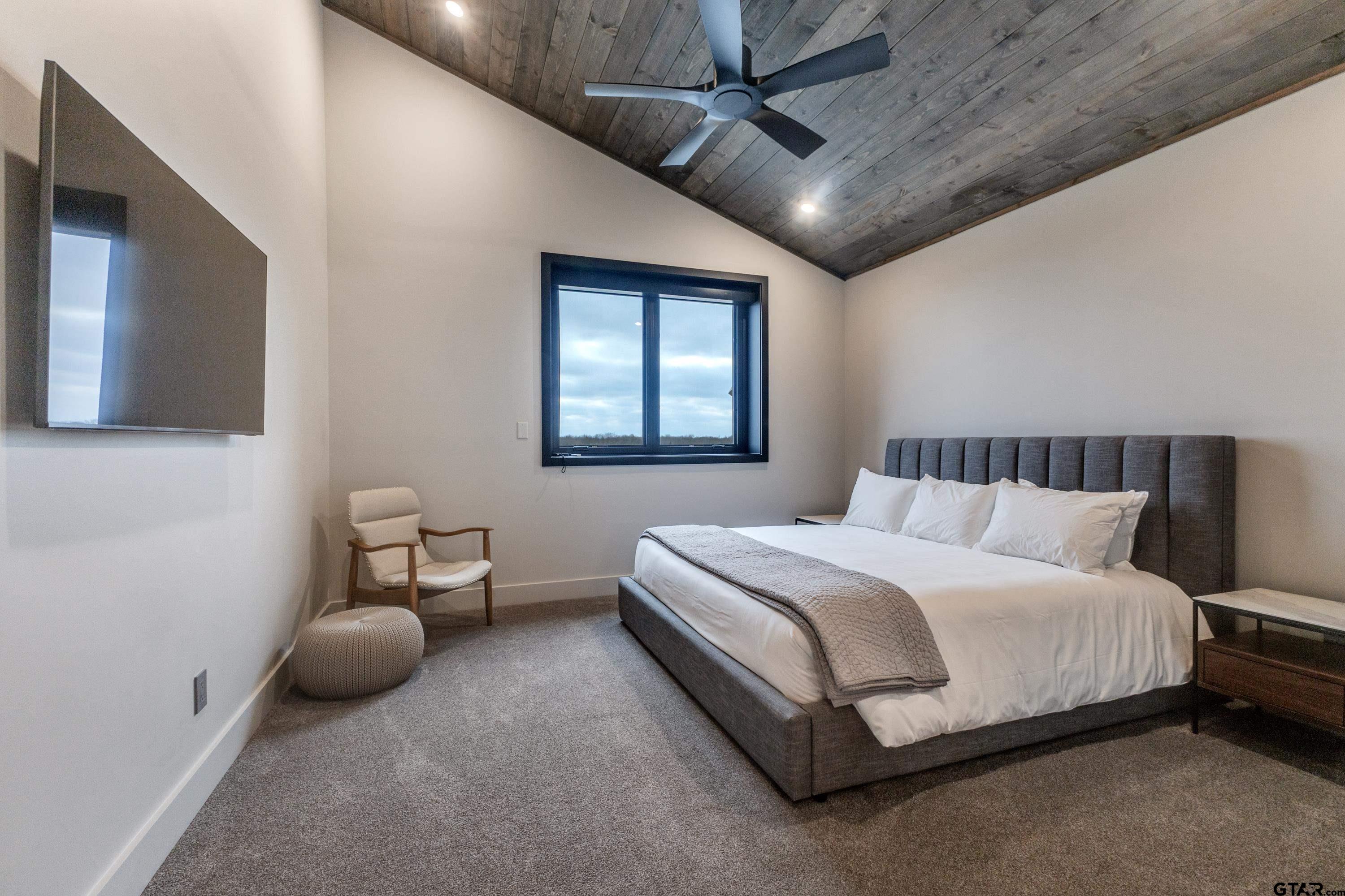 900 West Fm Saltillo, TX 75478 - Photo 12 of 36 a spacious bedroom with a bed a table and a couch