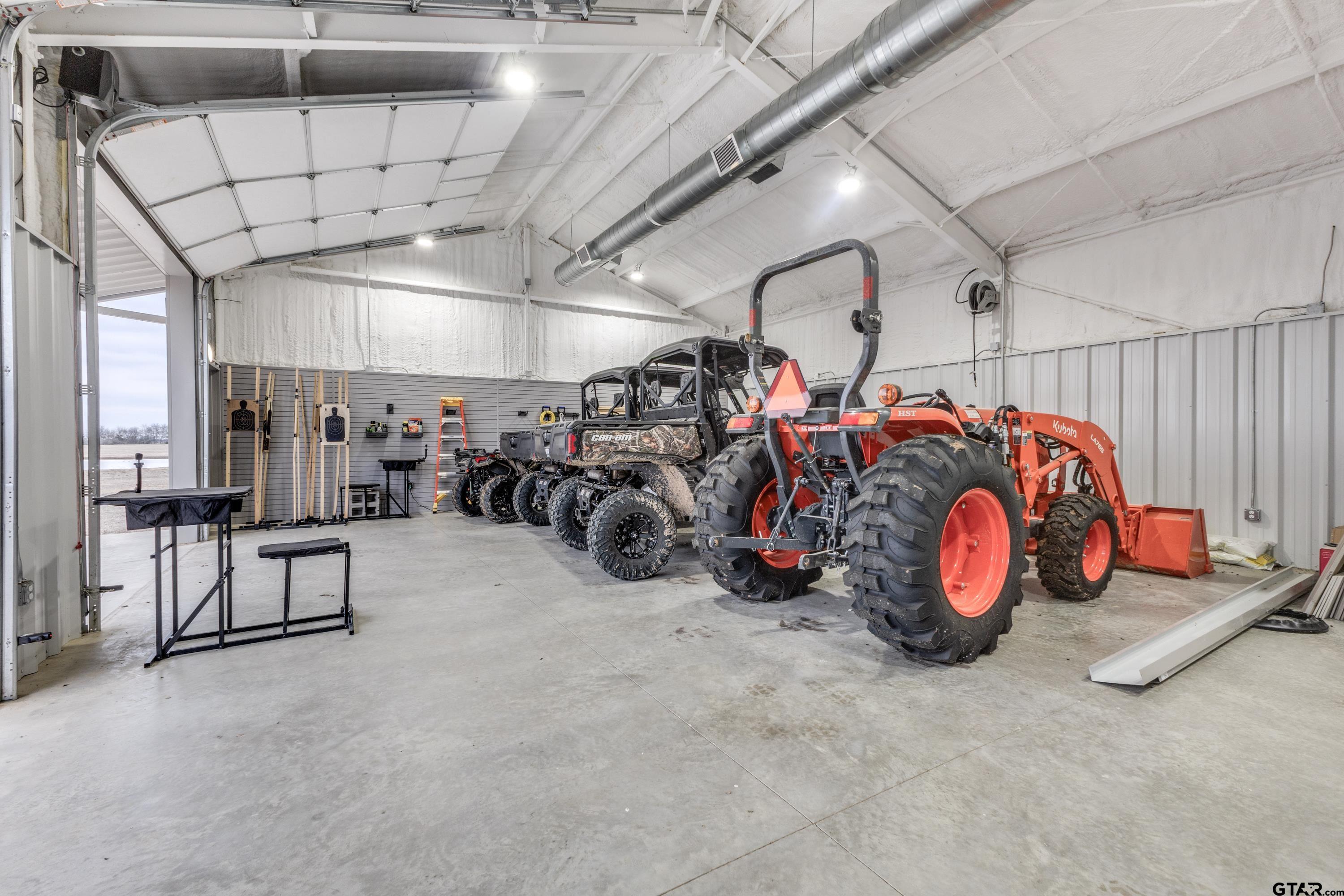 900 West Fm Saltillo, TX 75478 - Photo 28 of 36 a view of a garage with a bike and white roof