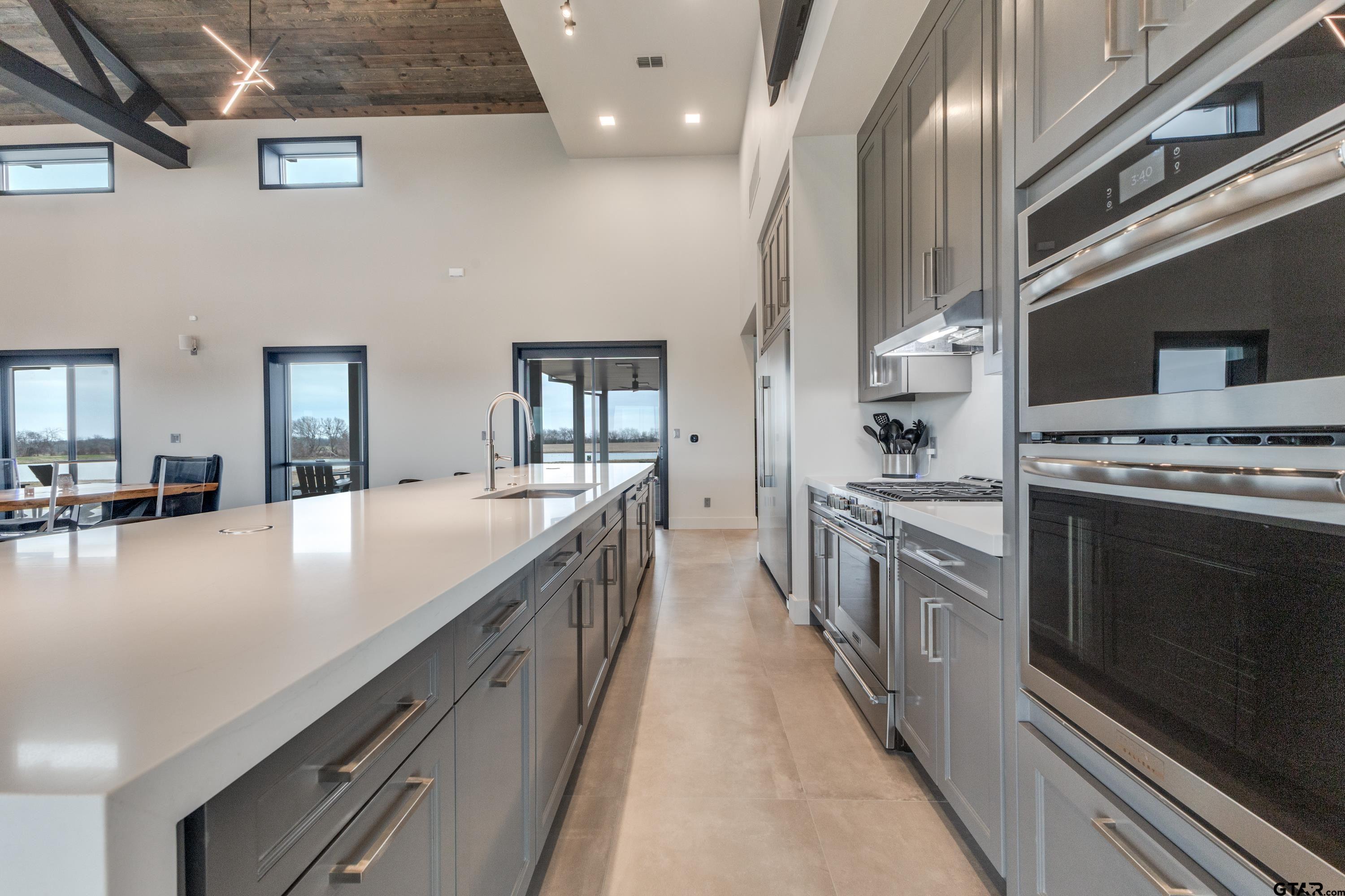 900 West Fm Saltillo, TX 75478 - Photo 8 of 36 a large kitchen with stainless steel appliances granite countertop a lot of counter space