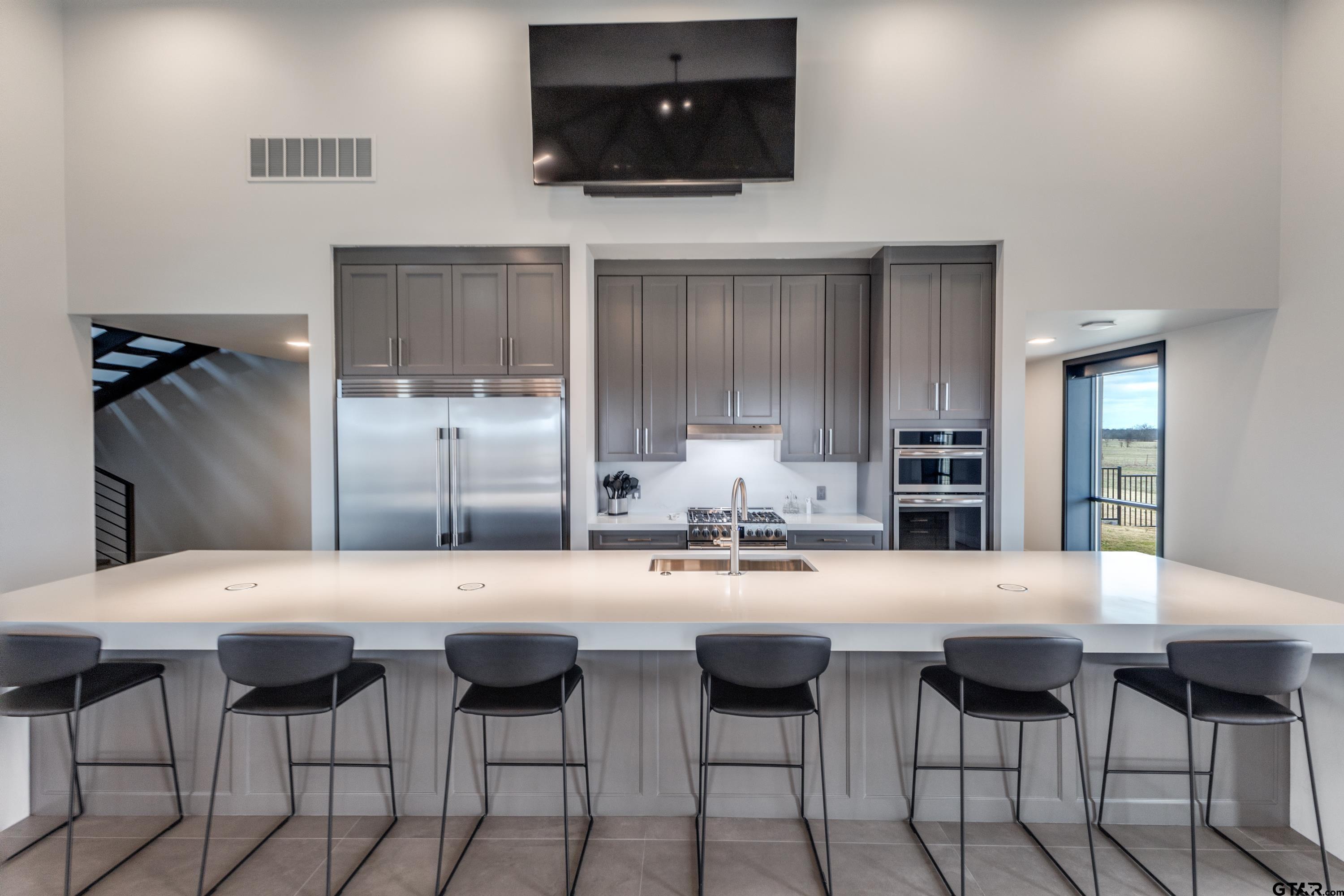 900 West Fm Saltillo, TX 75478 - Photo 10 of 36 a kitchen with stainless steel appliances a dining table and chairs