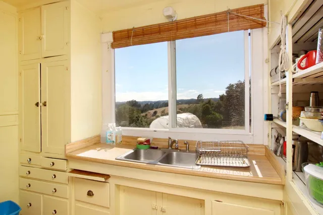 a kitchen with a stove and a window