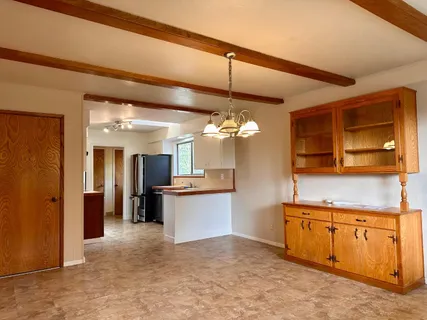 a bathroom with a sink a toilet and a window