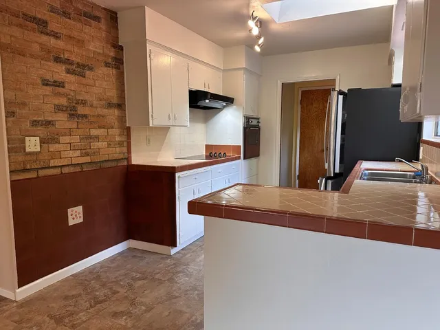 a picture of a bathroom with a glass door and a window