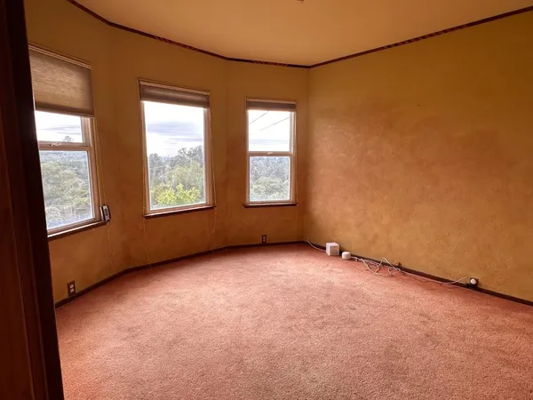 a view of an empty room with windows