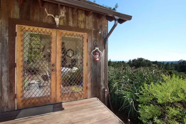 a backyard of a house with a garden and outdoor seating