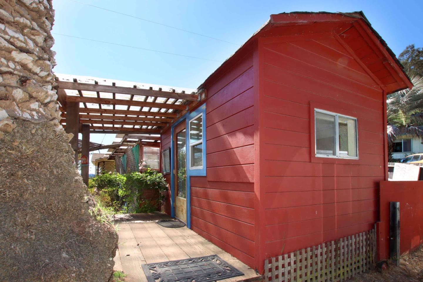 46 Valley View Road Watsonville, CA 95076 - Photo 48 of 55 a backyard of a house with potted plants and a bench