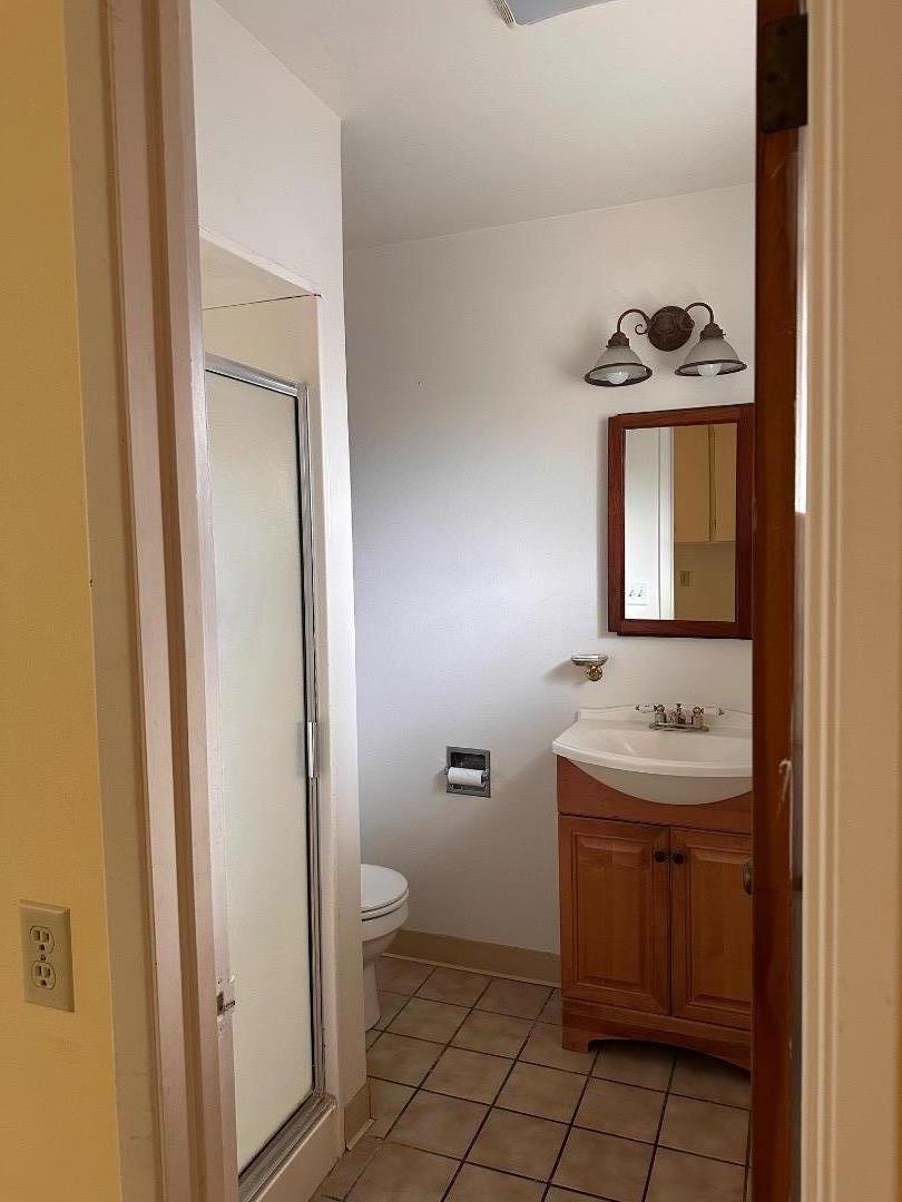 46 Valley View Road Watsonville, CA 95076 - Photo 52 of 55 a bathroom with a toilet a sink and mirror