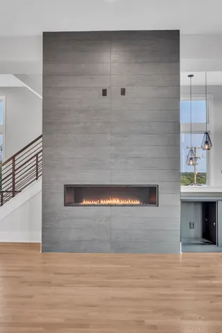 a large kitchen with kitchen island a sink wooden floor and glass doors