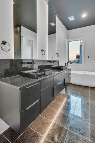 a kitchen with stainless steel appliances granite countertop a sink and stove top oven