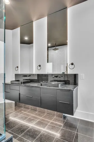 a kitchen with cabinets and wooden floor
