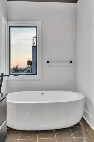 a open kitchen with stainless steel appliances granite countertop a refrigerator a sink and white cabinets with wooden floor