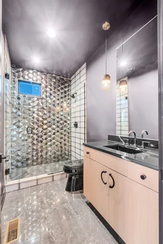a bathroom with a shower and a sink