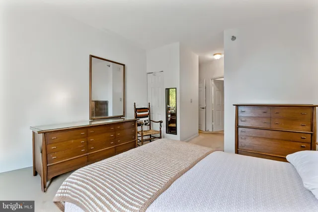 a bedroom with a bed and a dresser