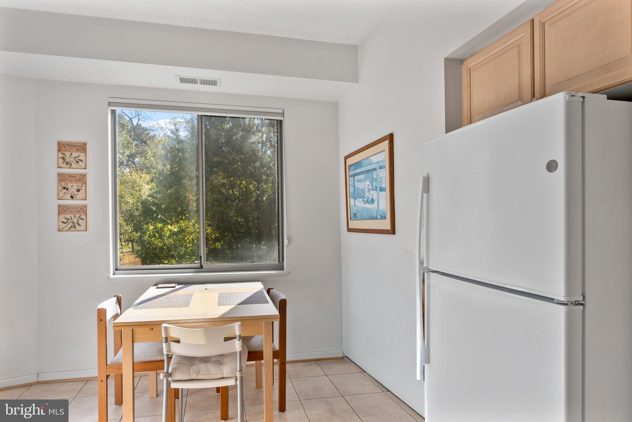 2900 North Leisure World Boulevard, Unit 301 Silver Spring, MD 20906 - Photo 7 of 30 a kitchen with a refrigerator a sink and a stove top oven