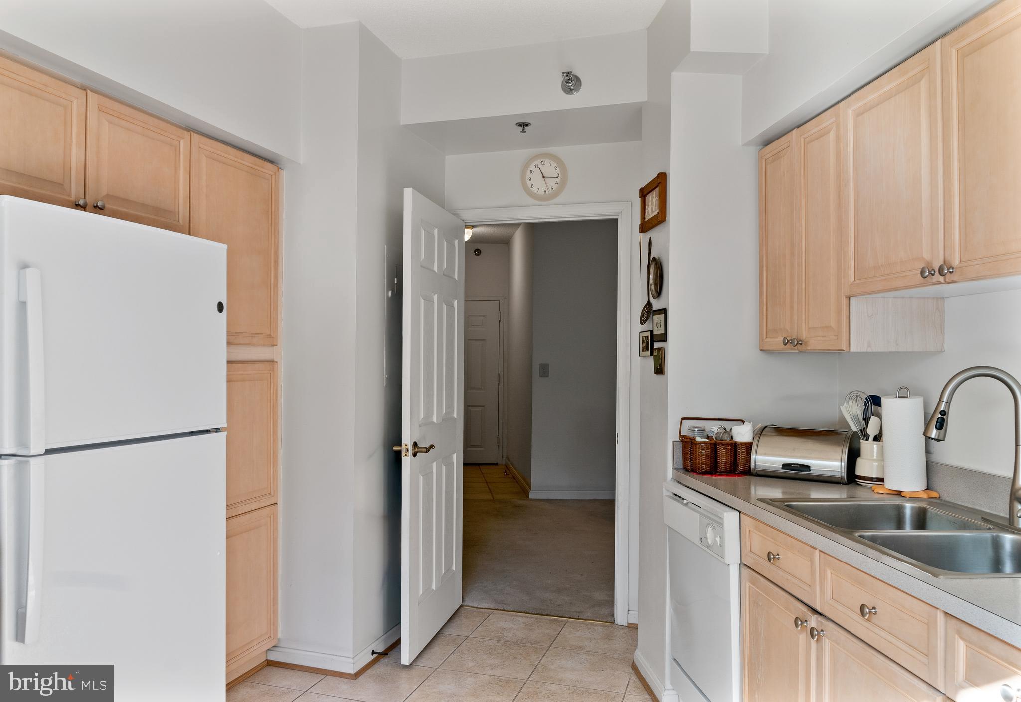 2900 North Leisure World Boulevard, Unit 301 Silver Spring, MD 20906 - Photo 8 of 30 a kitchen with a refrigerator and a sink