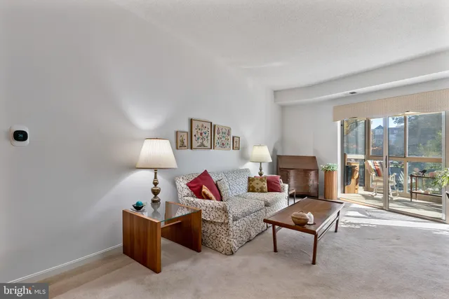 a living room with furniture and a lamp