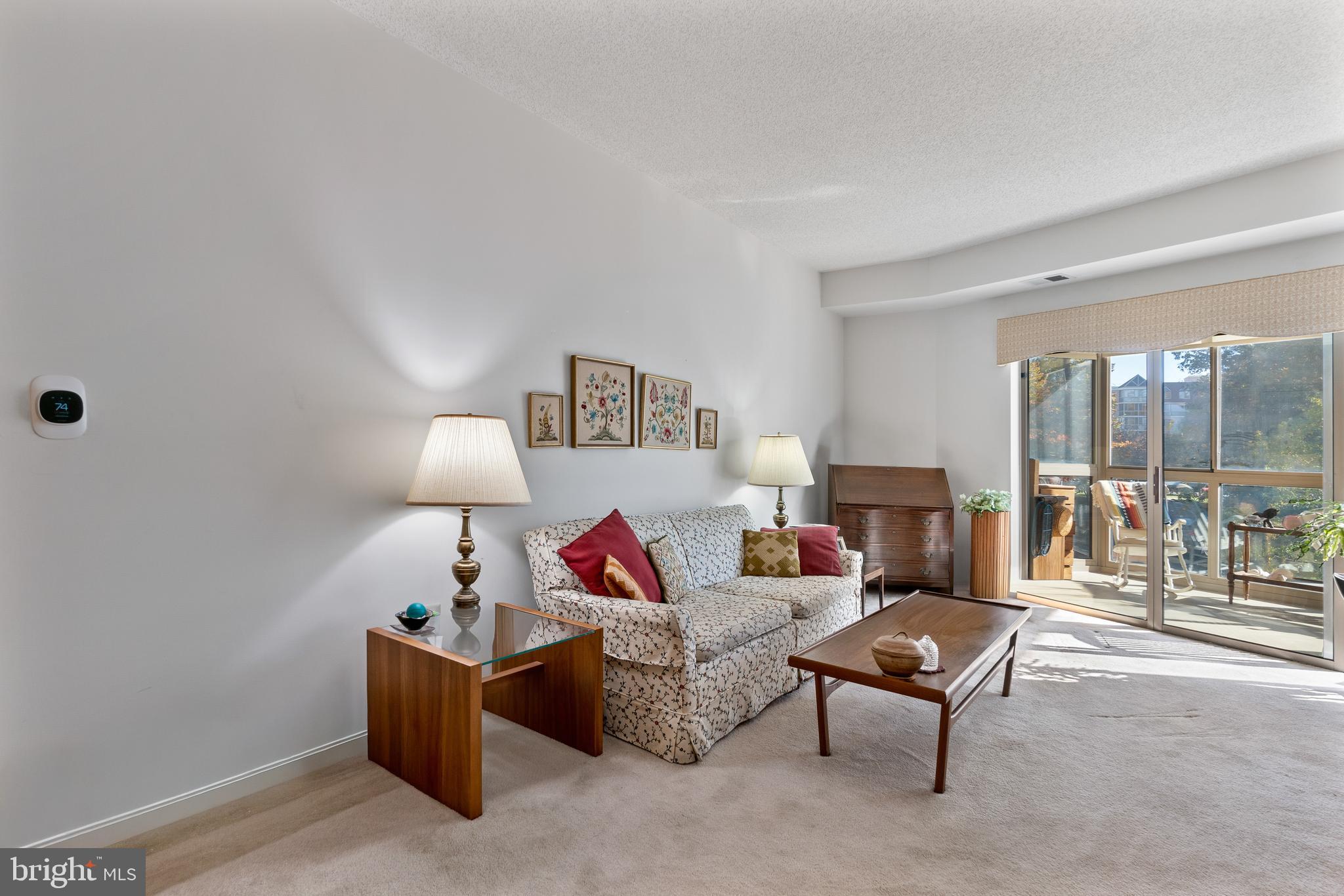 2900 North Leisure World Boulevard, Unit 301 Silver Spring, MD 20906 - Photo 10 of 30 a living room with furniture and a lamp