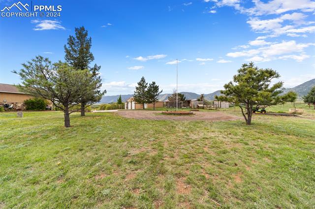 3240 Spaatz Road Monument, CO 80132 - Photo 6 of 45 Next to the worksop is a goat barn, a goat play area, a large chicken coop and chicken pen. A lit flag pole anchors a circle drive!