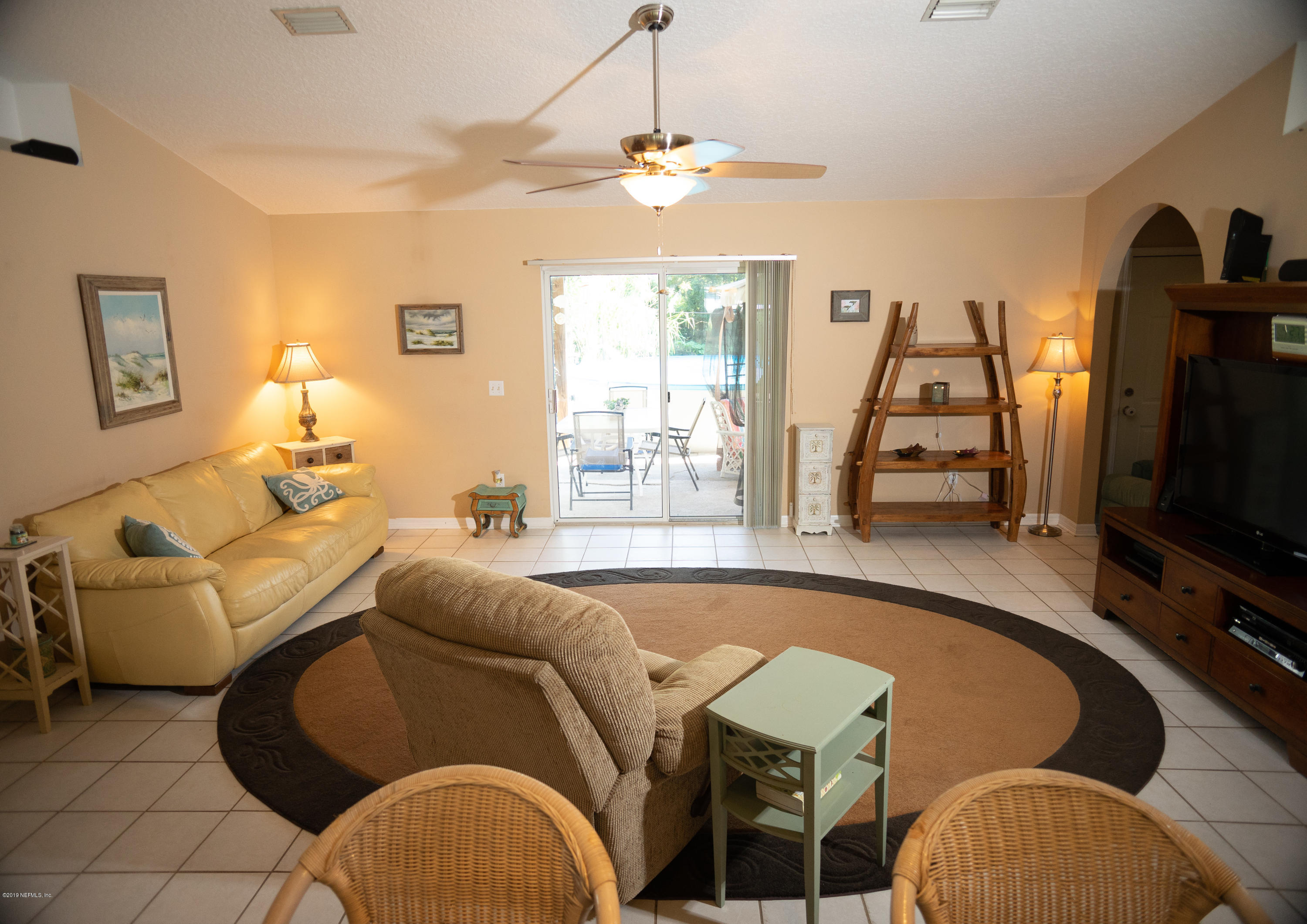 570 Ruba Road St. Augustine, FL 32086 - Photo 11 of 27 a living room with furniture a flat screen tv and a window
