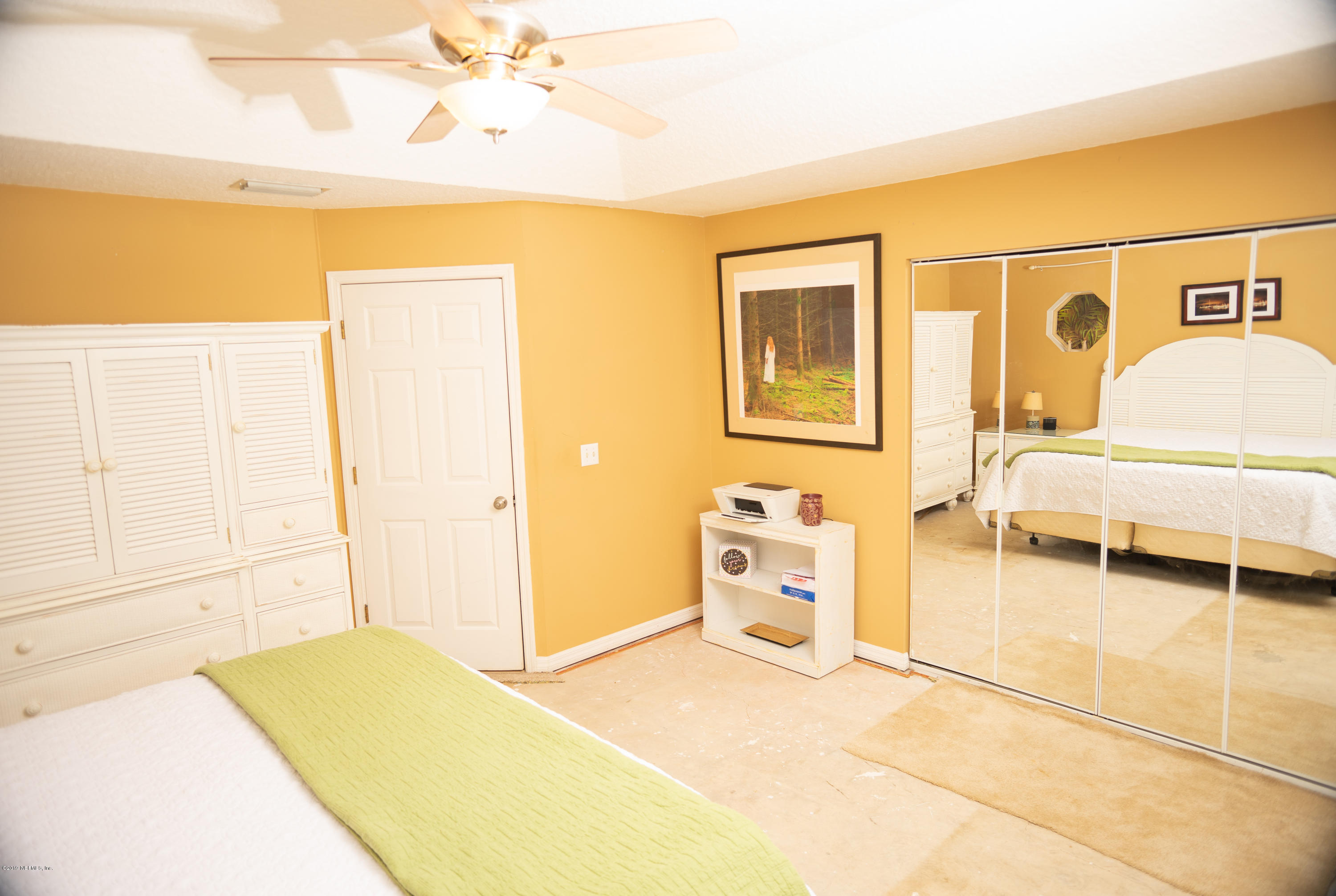 570 Ruba Road St. Augustine, FL 32086 - Photo 15 of 27 a bedroom with a bed and a cabinets