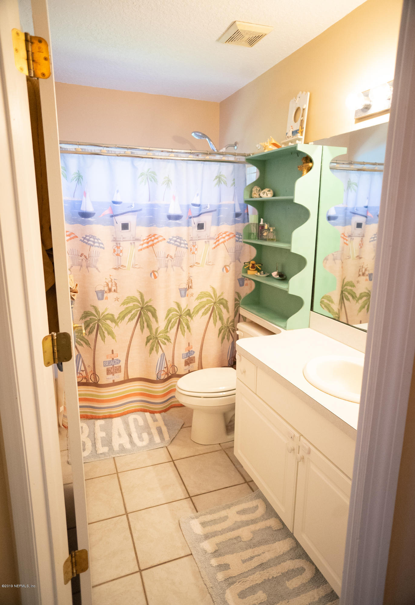 570 Ruba Road St. Augustine, FL 32086 - Photo 16 of 27 a bathroom with a granite countertop bathtub next to a window