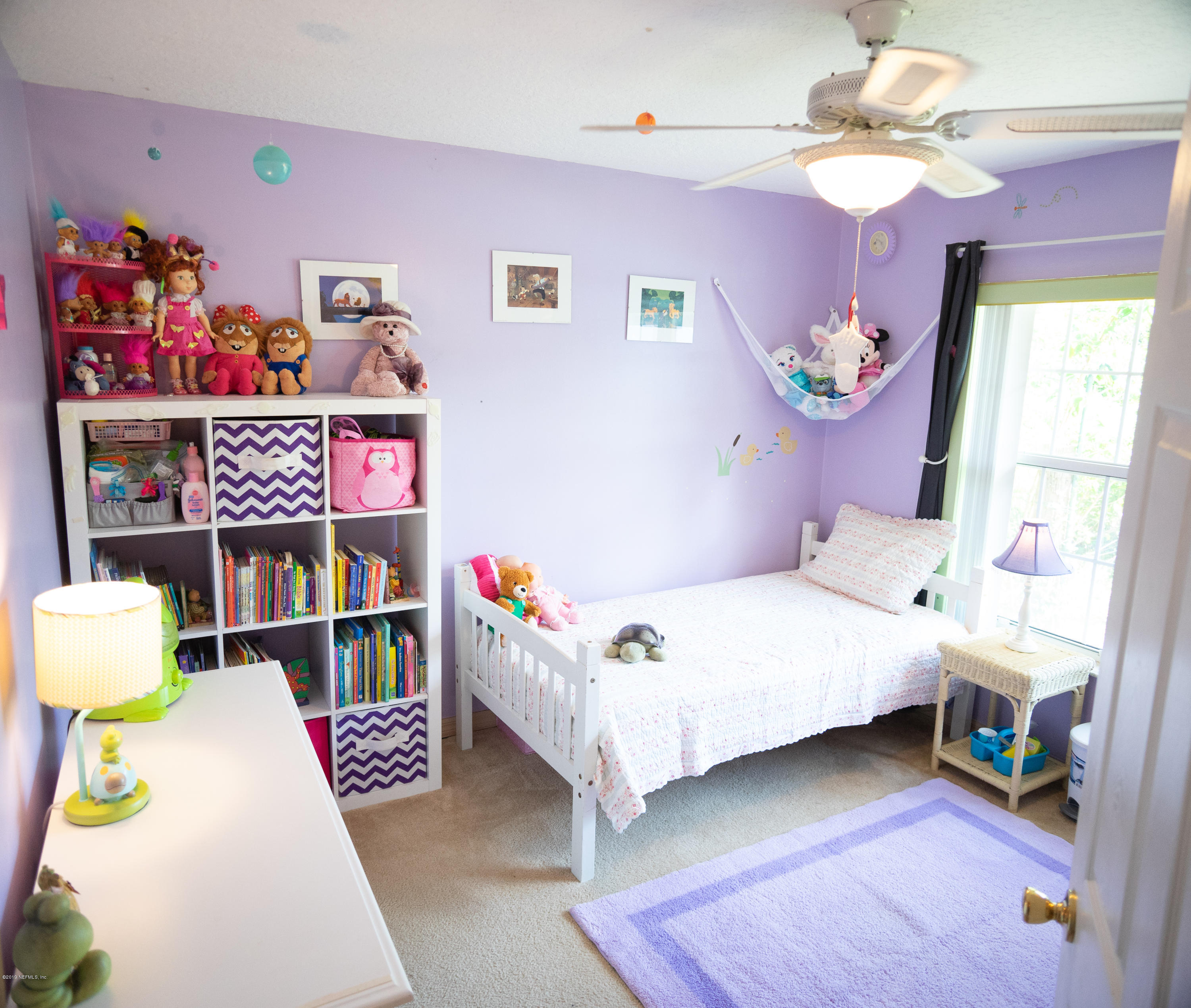 570 Ruba Road St. Augustine, FL 32086 - Photo 17 of 27 a bedroom with a bed and a chandelier