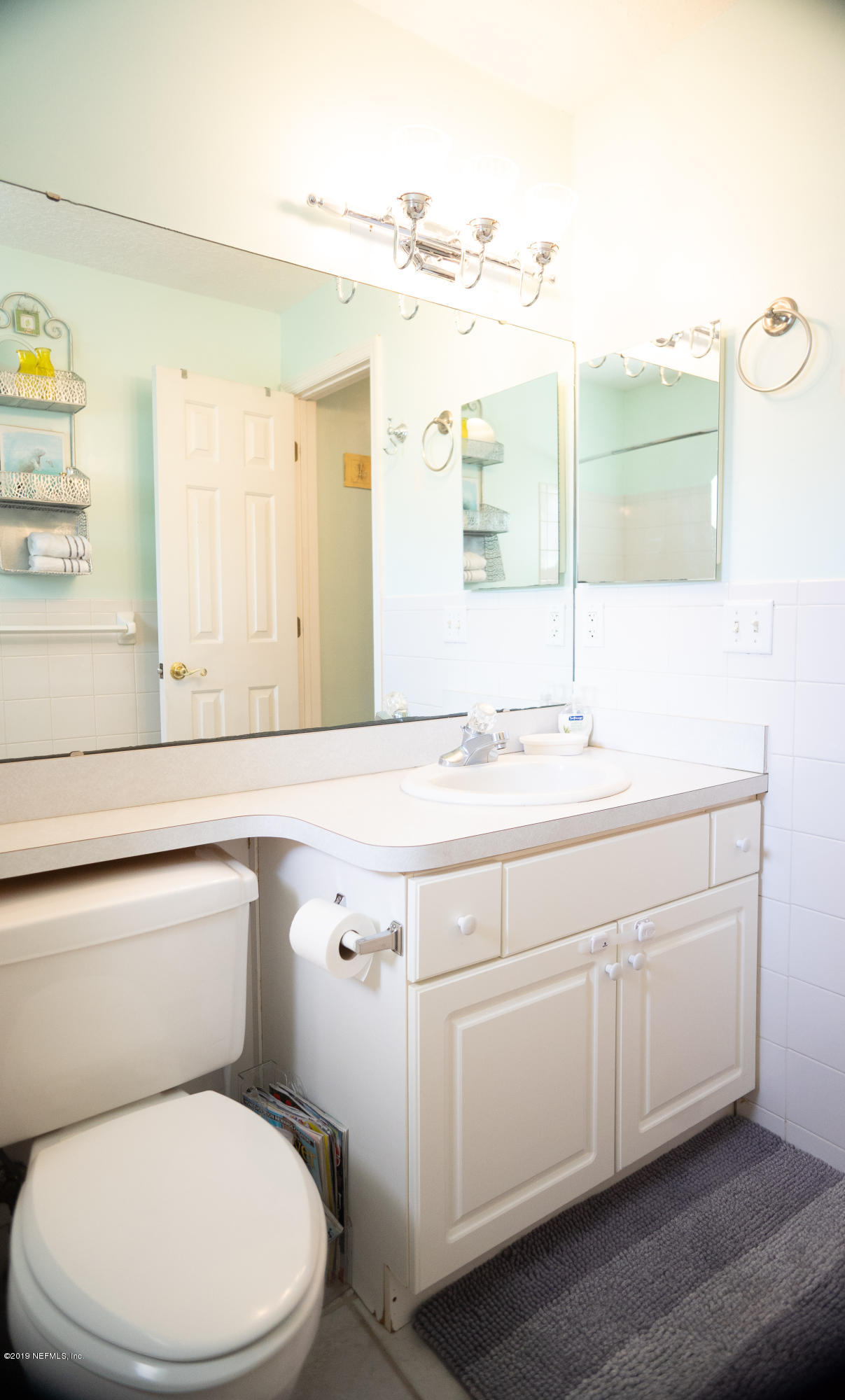 570 Ruba Road St. Augustine, FL 32086 - Photo 20 of 27 a bathroom with a granite countertop toilet sink and mirror