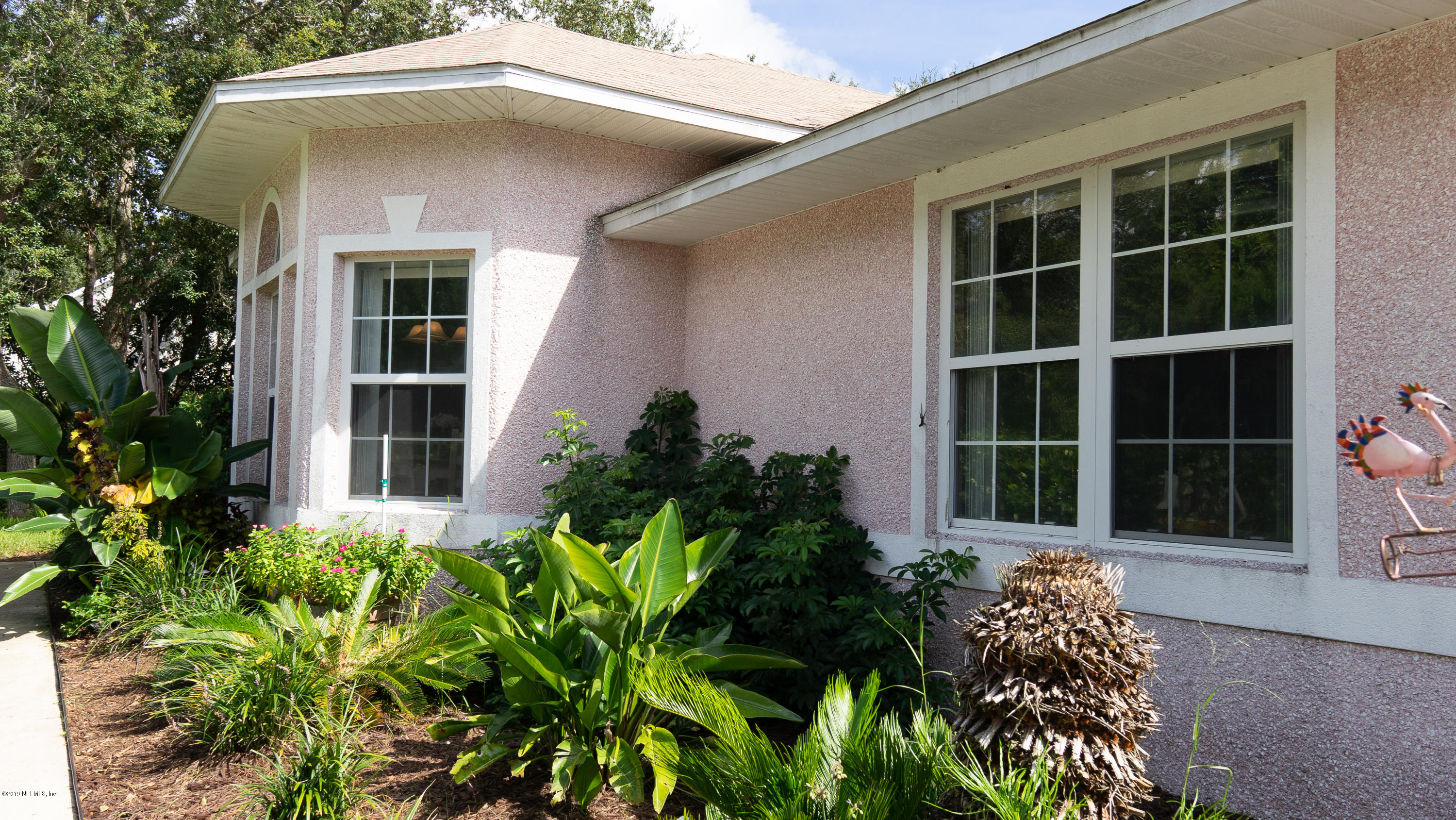 570 Ruba Road St. Augustine, FL 32086 - Photo 2 of 27 a front view of a house with a yard and potted plants