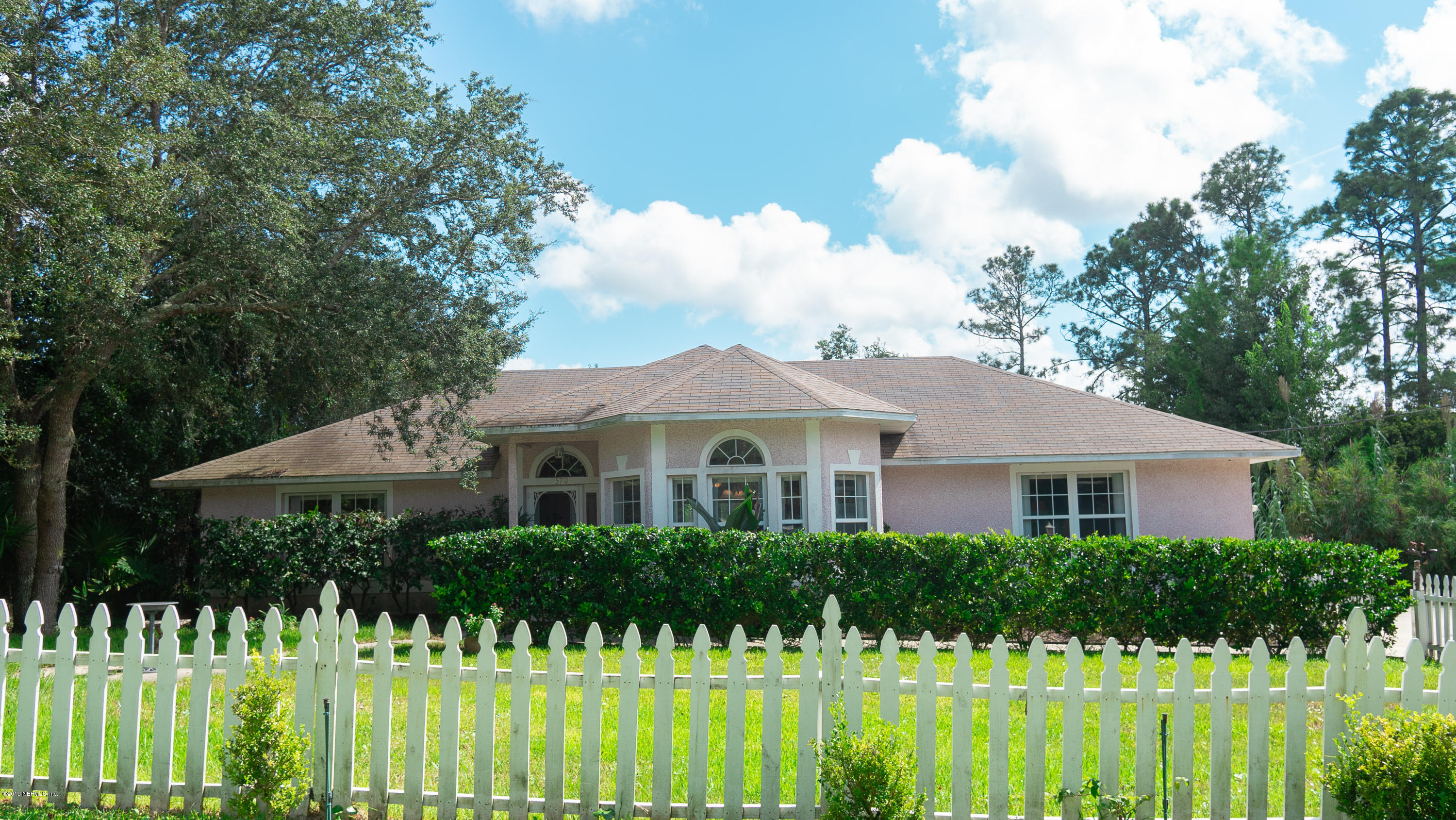 570 Ruba Road St. Augustine, FL 32086 - Photo 3 of 27 a front view of a house with a garden