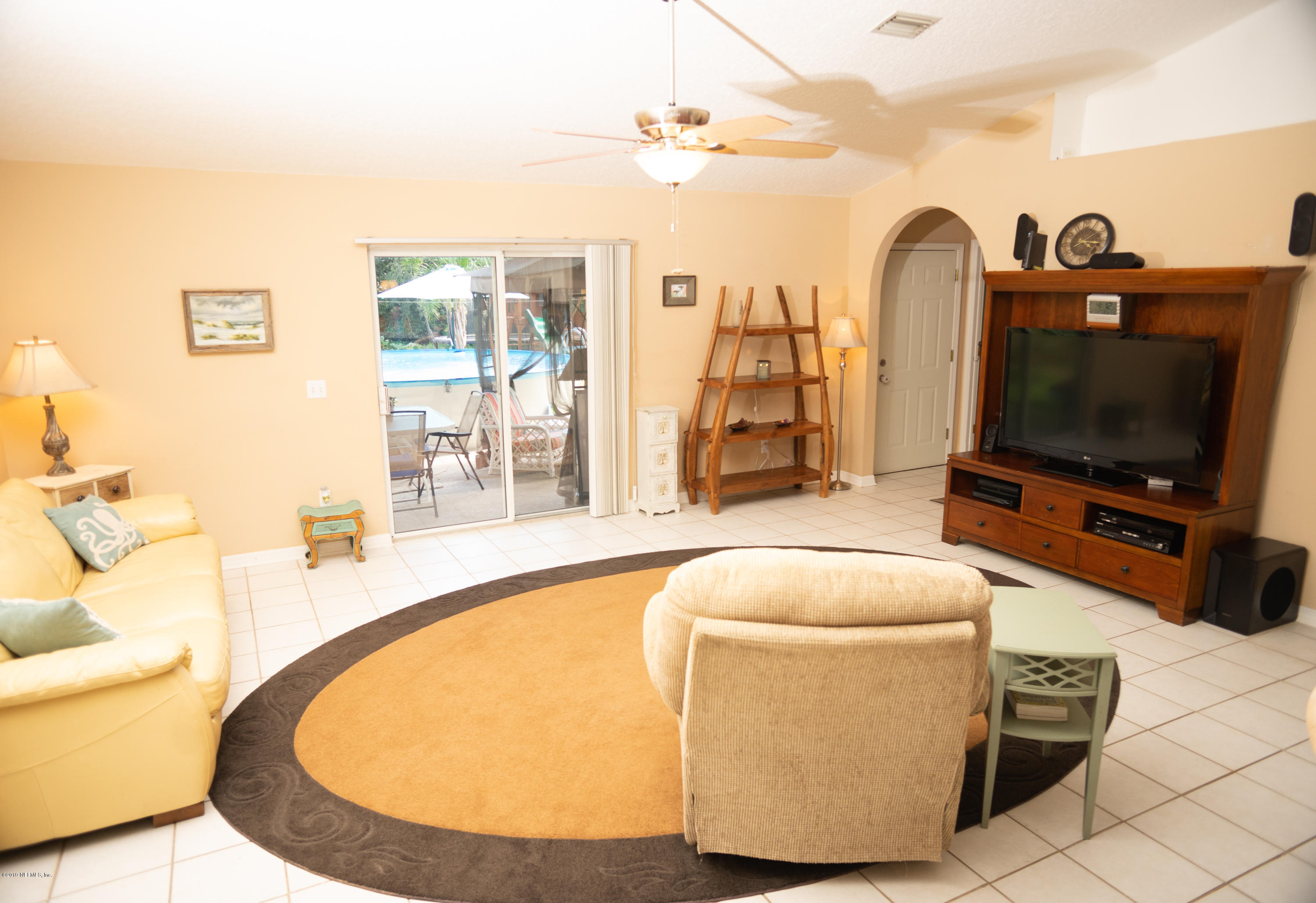 570 Ruba Road St. Augustine, FL 32086 - Photo 9 of 27 a living room with furniture and a flat screen tv