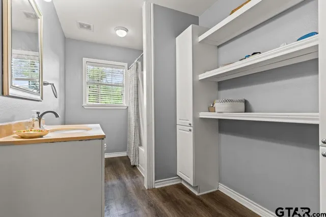 a view of a kitchen with a sink and a window