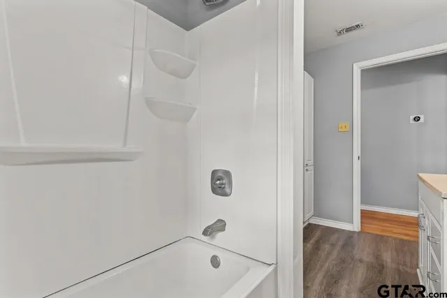 a bathroom with a tub and shower