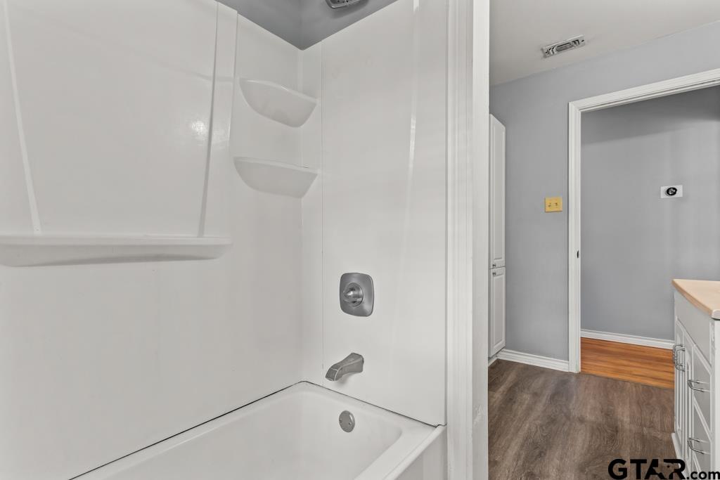 2144 State Highway 155 Gilmer, TX 75644 - Photo 15 of 26 a bathroom with a tub and shower
