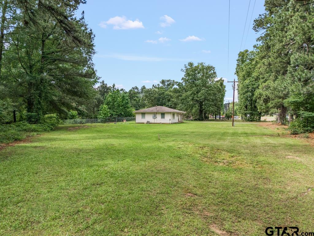 2144 State Highway 155 Gilmer, TX 75644 - Photo 21 of 26 a building with trees in the background