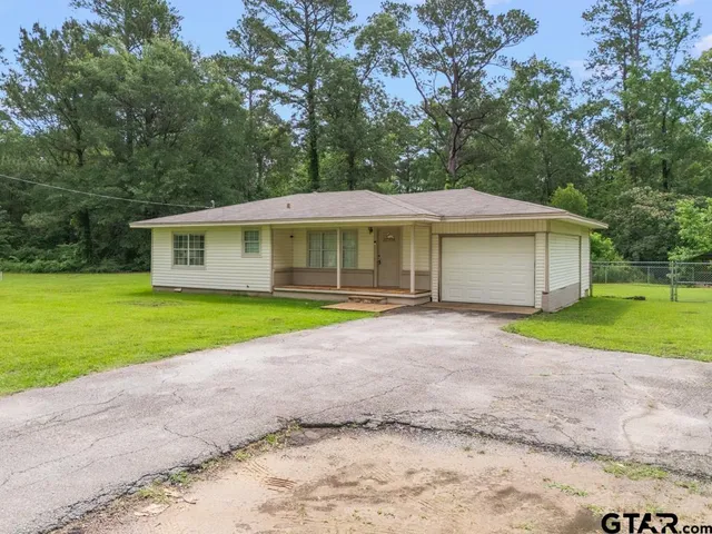 a house with a yard and a large parking space