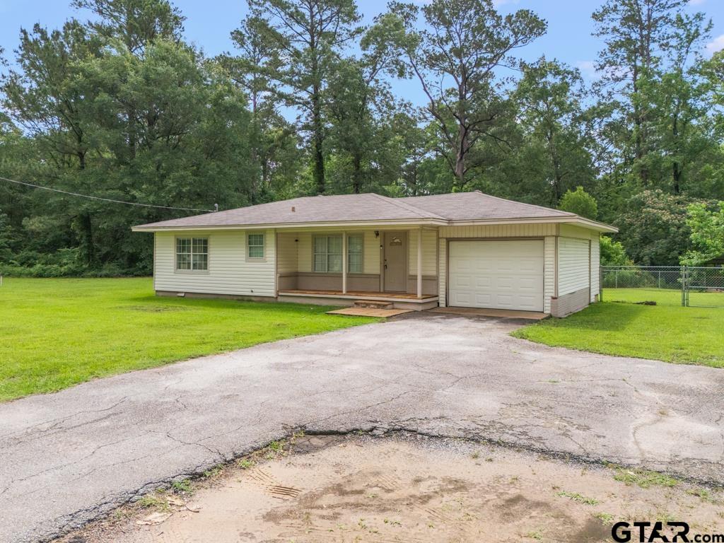 2144 State Highway 155 Gilmer, TX 75644 - Photo 23 of 26 a house with a yard and a large parking space