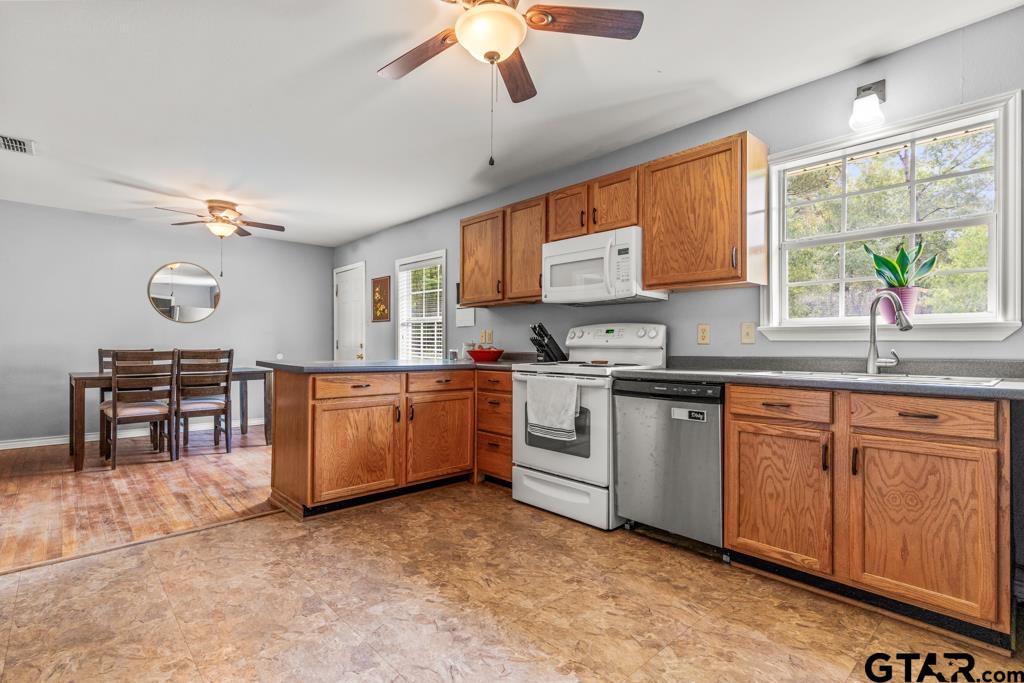 2144 State Highway 155 Gilmer, TX 75644 - Photo 7 of 26 a kitchen with a sink stove and microwave