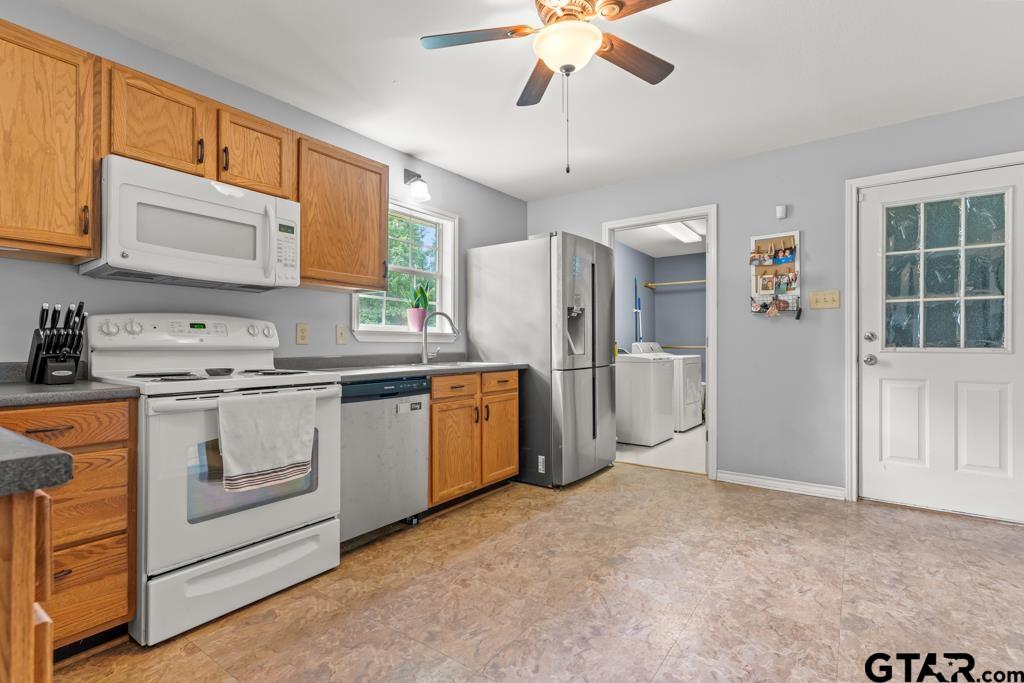 2144 State Highway 155 Gilmer, TX 75644 - Photo 8 of 26 a kitchen with refrigerator cabinets and window