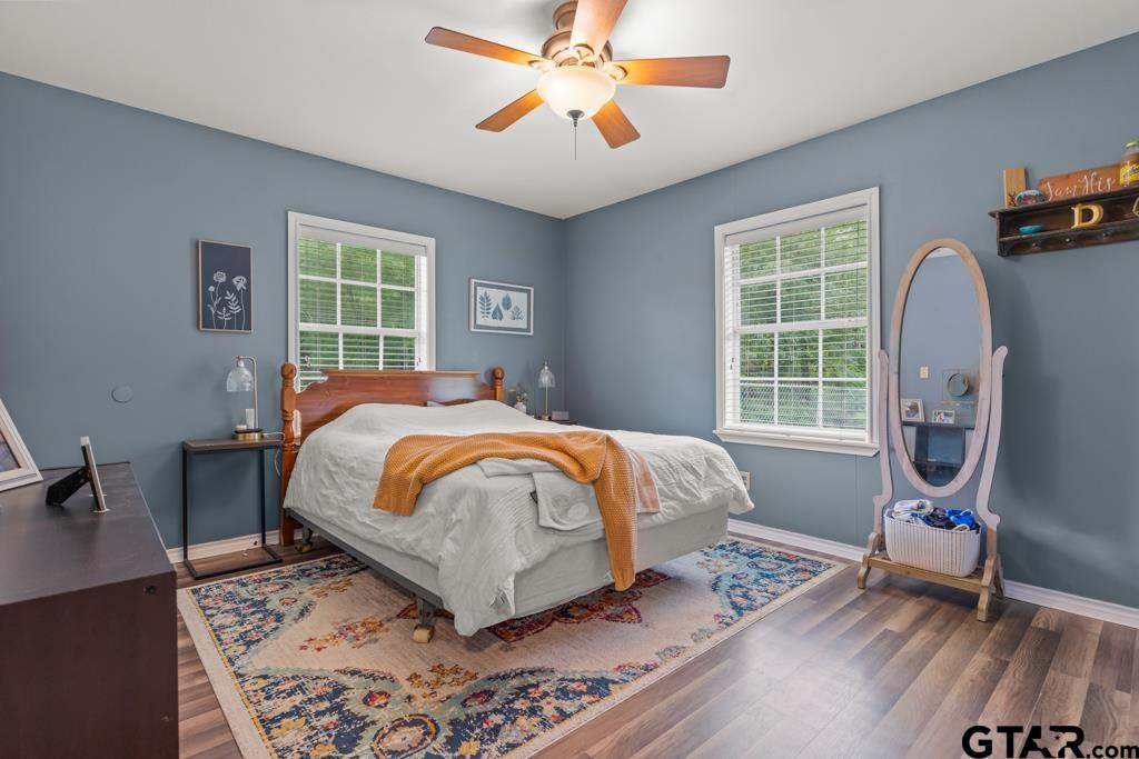 2144 State Highway 155 Gilmer, TX 75644 - Photo 10 of 26 a bedroom with a bed a chandelier and a window