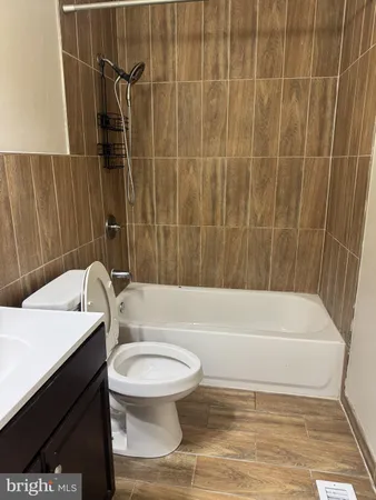 a bathroom with a sink a toilet and bathtub