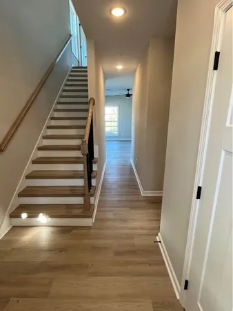 a view of entryway and hall with wooden floor