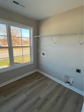 a view of a room with rack on the wall and a window