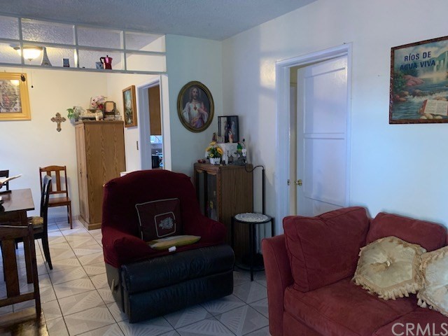 2314 West Alondra Boulevard Compton, CA 90220 - Photo 3 of 15 a living room with furniture and a refrigerator