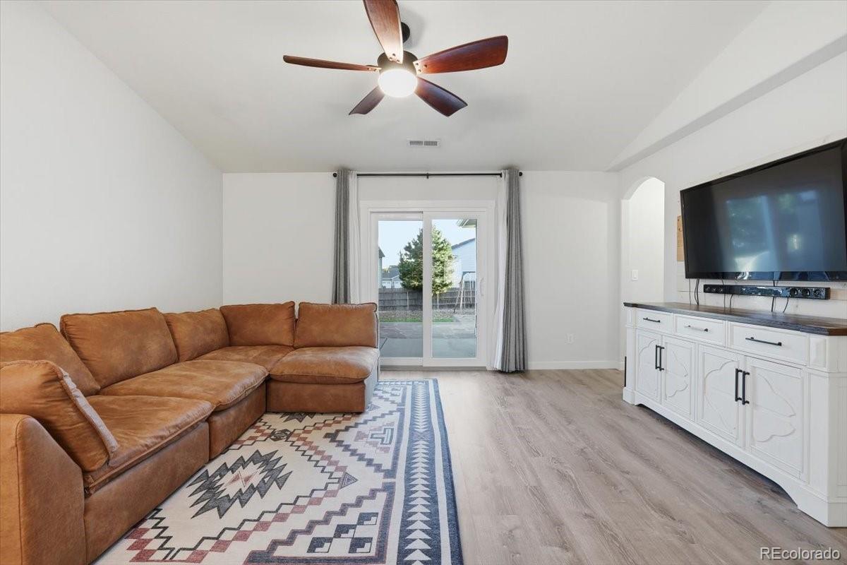 12209 Crystal Downs Road Peyton, CO 80831 - Photo 13 of 37 a living room with furniture and a flat screen tv