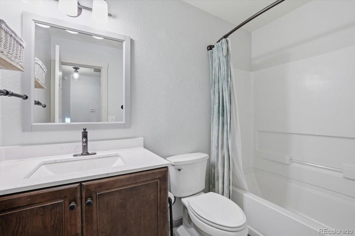 12209 Crystal Downs Road Peyton, CO 80831 - Photo 15 of 37 a bathroom with a sink a toilet and shower
