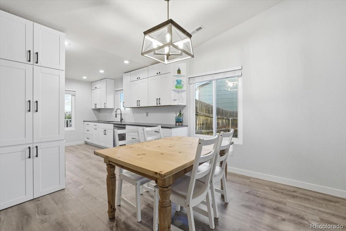 12209 Crystal Downs Road Peyton, CO 80831 - Photo 2 of 37 a kitchen with a table and chairs in it