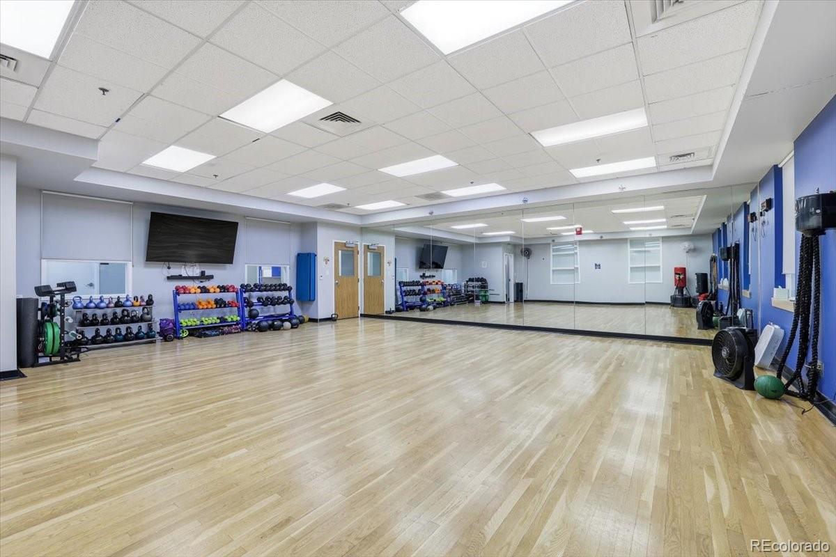 12209 Crystal Downs Road Peyton, CO 80831 - Photo 29 of 37 a view of a room with gym equipment and a flat screen tv