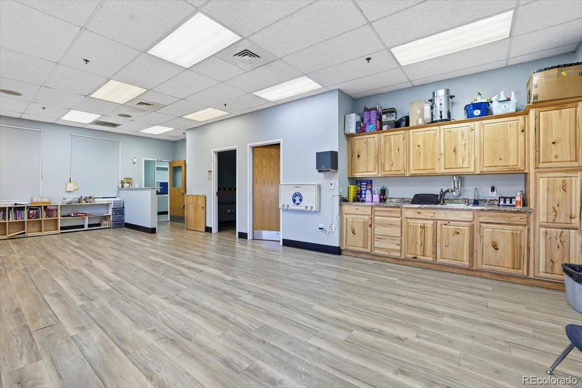 12209 Crystal Downs Road Peyton, CO 80831 - Photo 30 of 37 a view of a kitchen with furniture and wooden floor