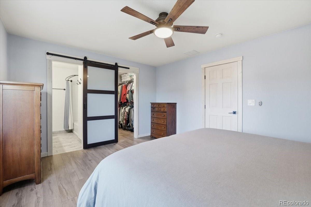 12209 Crystal Downs Road Peyton, CO 80831 - Photo 6 of 37 a bedroom with a bed and a ceiling fan