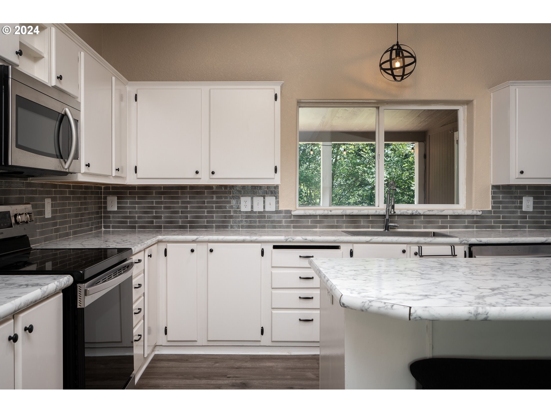 6007 Northeast Lessard Road Camas, WA 98607 - Photo 21 of 48 a kitchen with granite countertop a sink window and cabinets